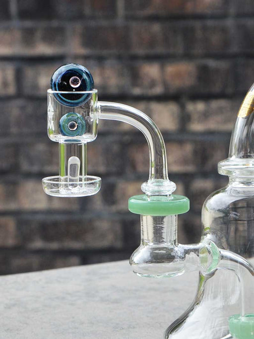 AFM terp slurper banger with 2 marbles and a quartz pillar inserted into a dab rig.